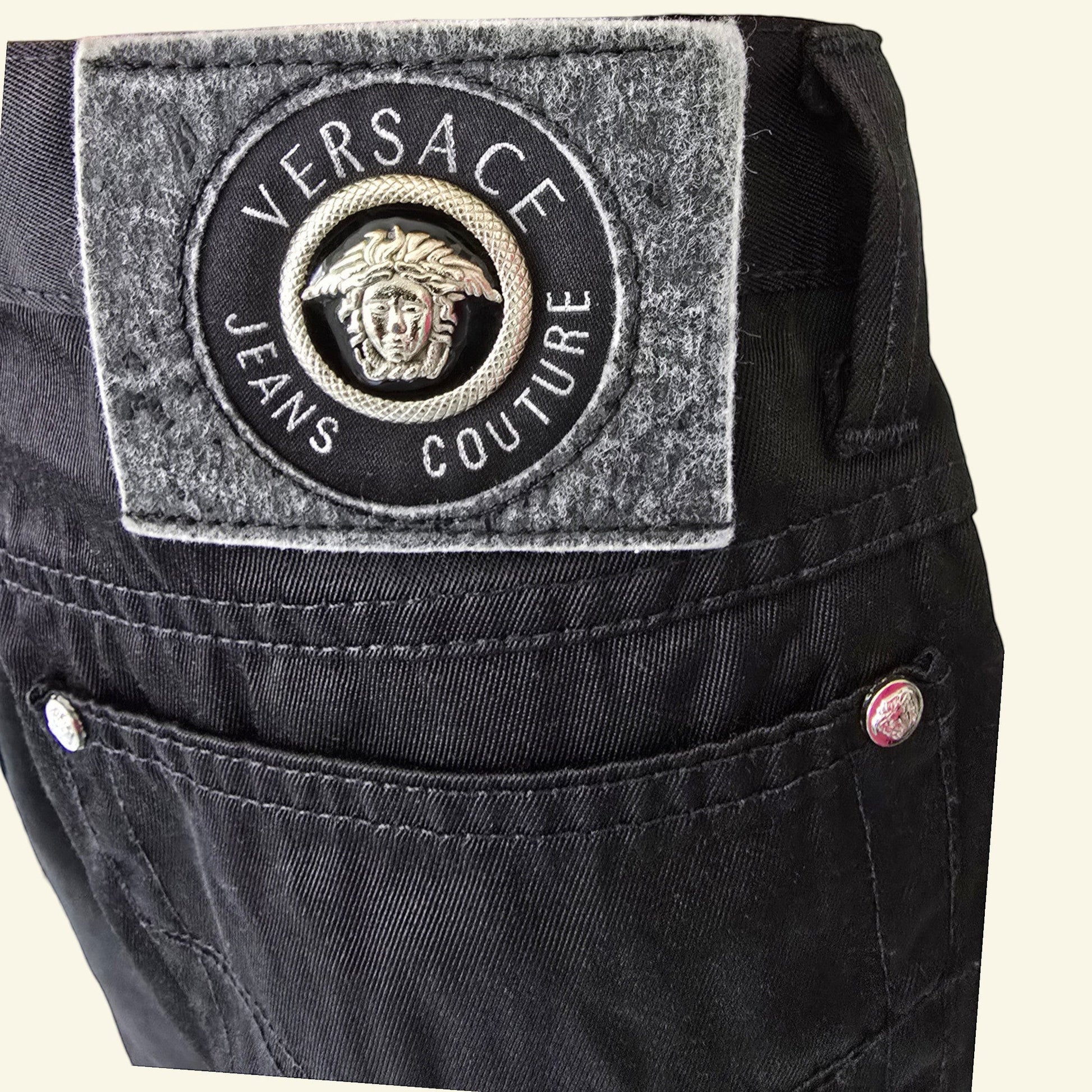 Timelessfashions Versace black cotton skinny jeans with Medusa logo patch and silver button details.