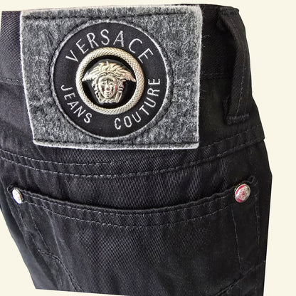 Timelessfashions Versace black cotton skinny jeans with Medusa logo patch and silver button details.