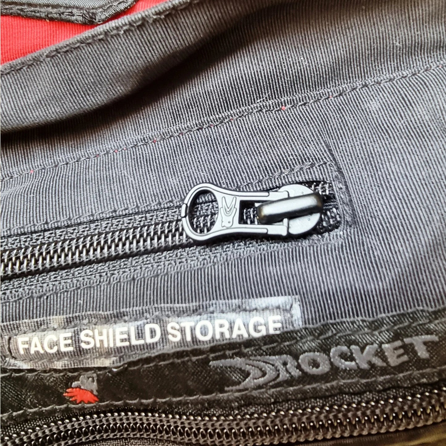 Timelessfashions Honda Joe Rocket women's black textile motorbike jacket with adjustable straps, protective padding, and 'Face Shield Storage' detail.