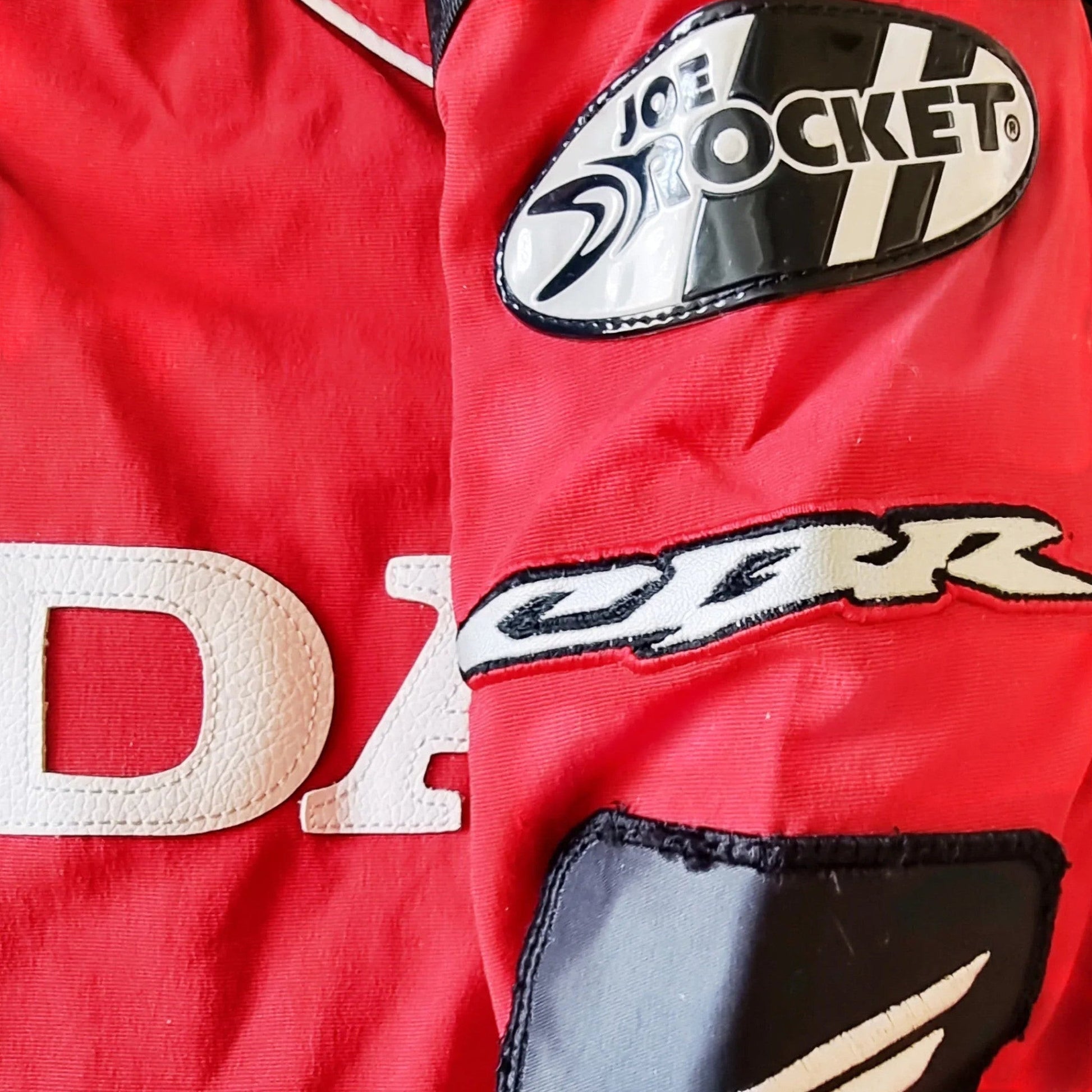 Timelessfashions Honda Joe Rocket red motorcycle jacket with white CBR lettering and protective padding.