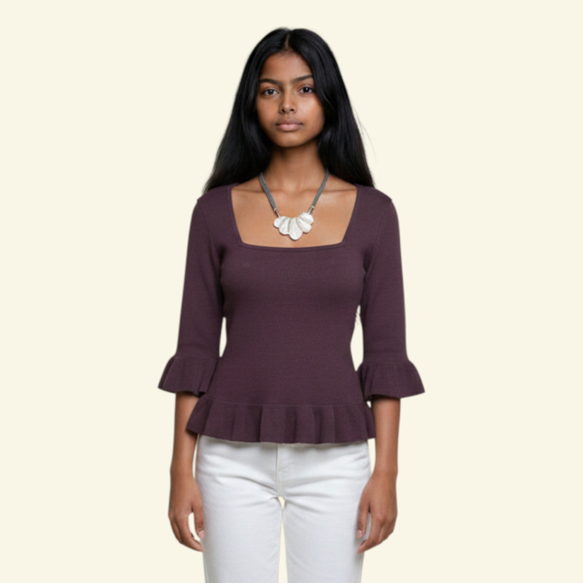 Model wearing a taupe cotton blend top with square neckline, ruffled mid-length sleeves, and peplum hem. Model wears size UK 12.