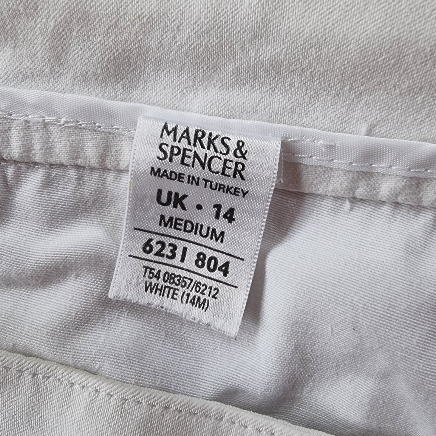 Marks & Spencer label on a white garment with text details.