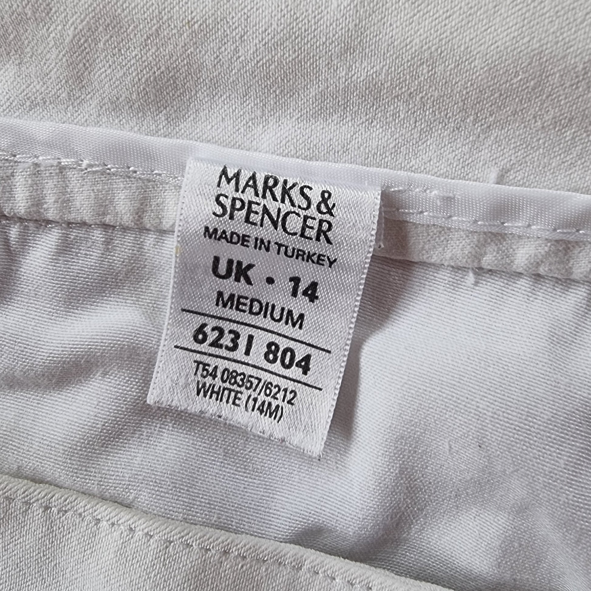 Marks & Spencer label on a white garment with text details.