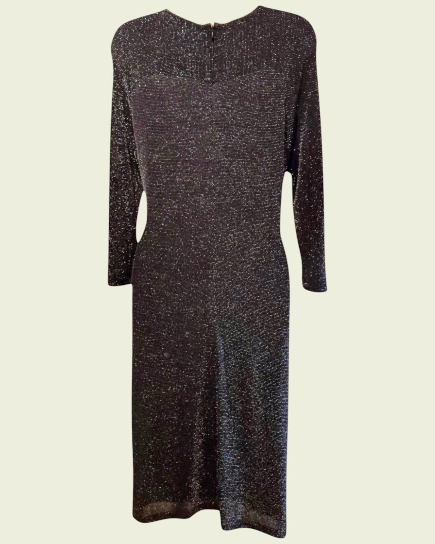 Black glitter dress on a beige background