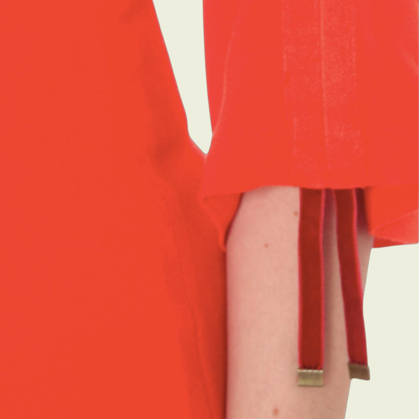 Red dress with a gold trim on a plain background