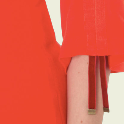 Red dress with a gold trim on a plain background