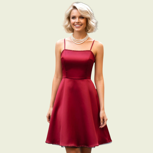 Woman wearing a red dress with a beige background