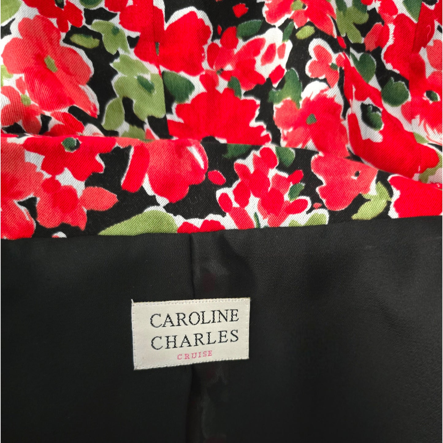 Floral patterned fabric with a visible brand label on a black background