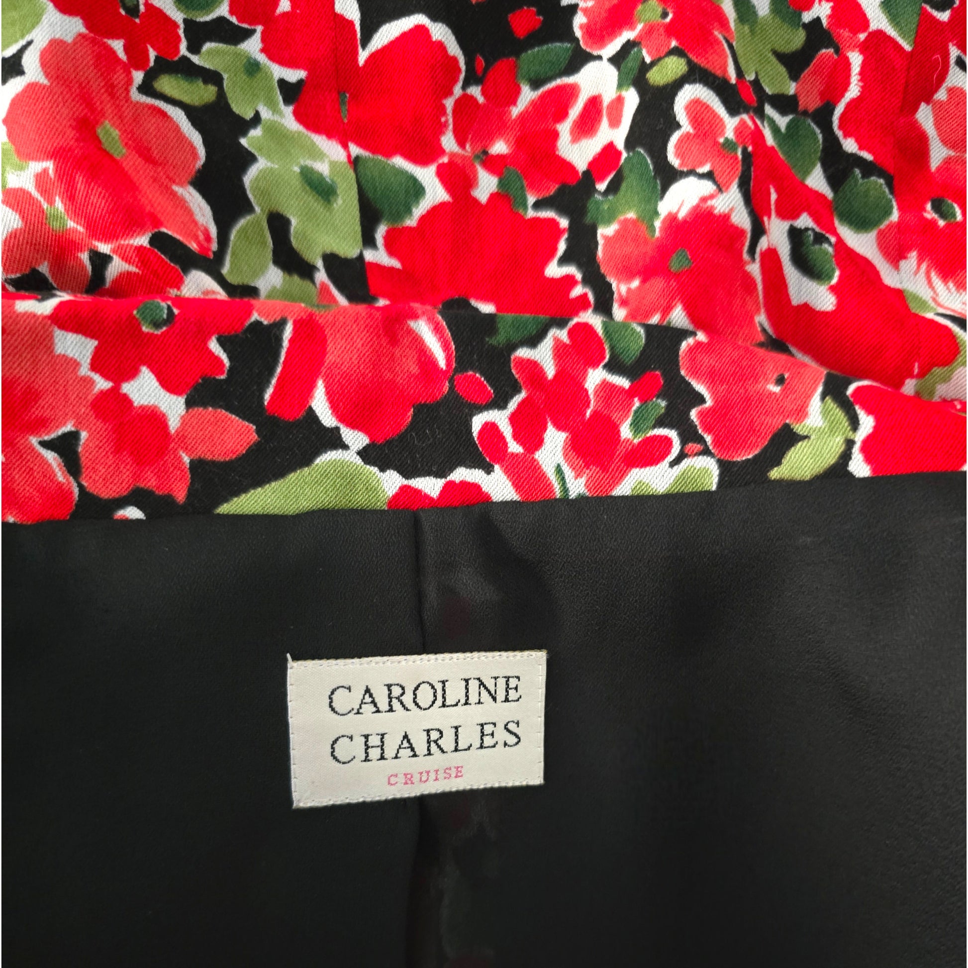 Floral patterned fabric with a visible brand label on a black background