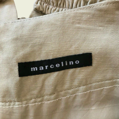 Clothing label showing MARCELINO on beige background