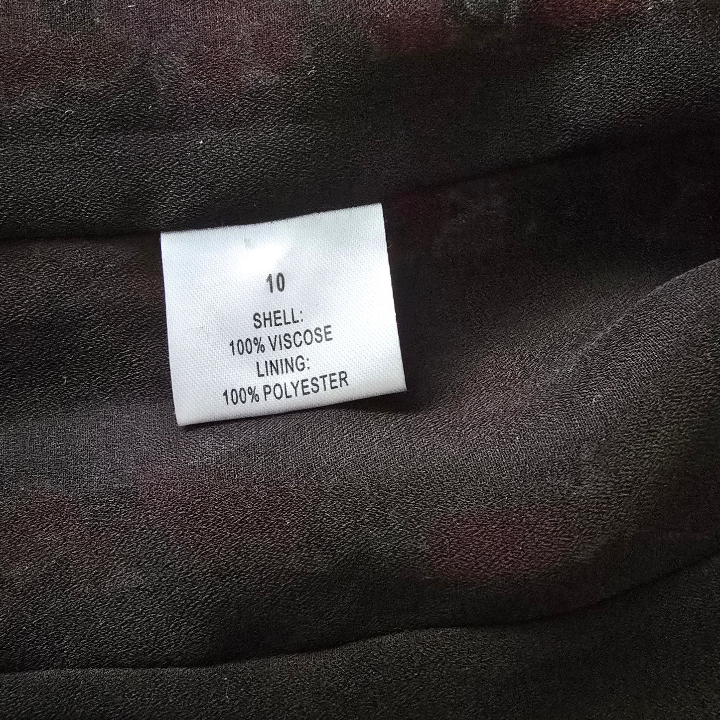 Clothing label on a dark fabric background