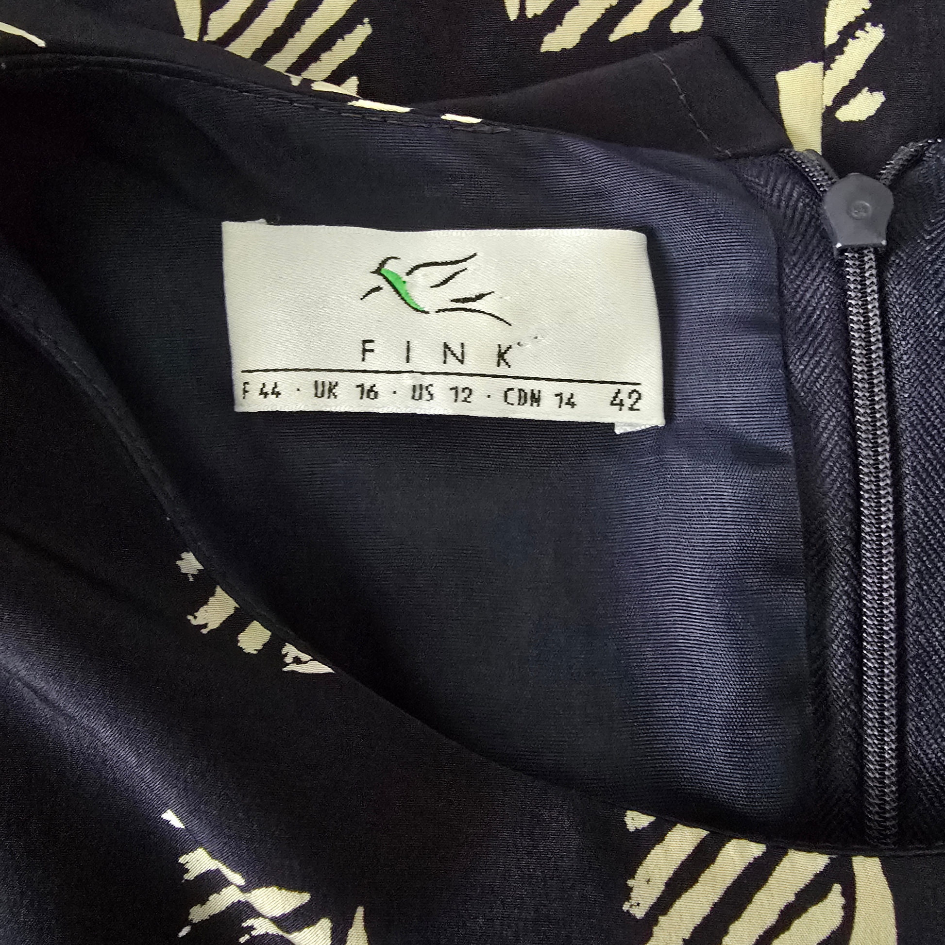 Fink label on a black garment with a pattern