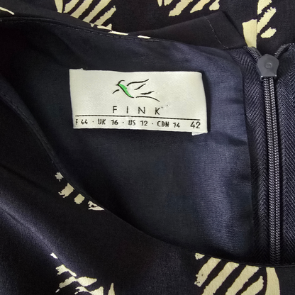 Fink label on a black garment with a pattern