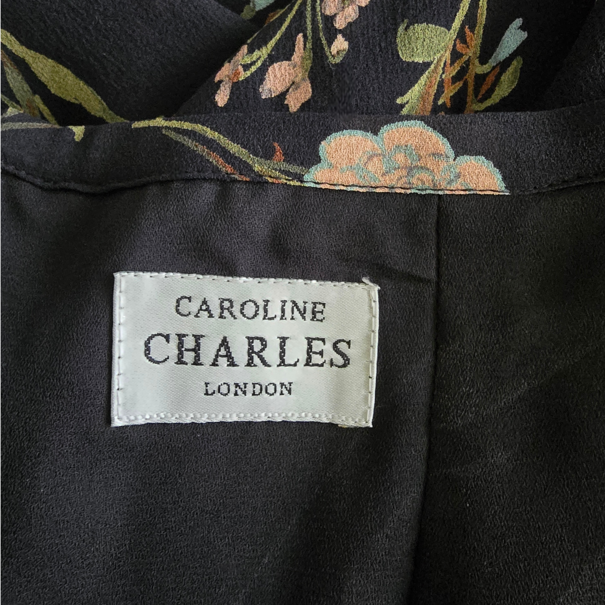 Garment label showing Caroline Charles London on black background
