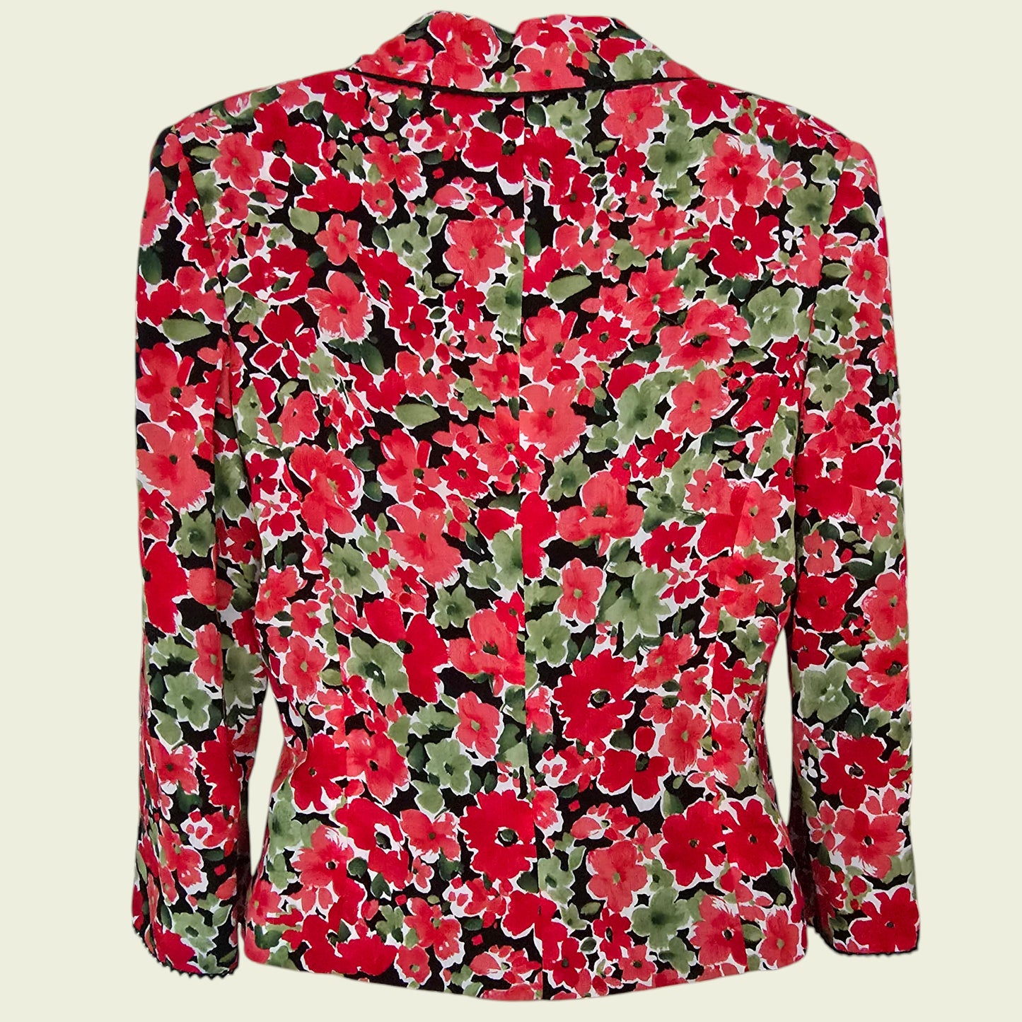 Floral patterned jacket with red and green flowers on a beige background