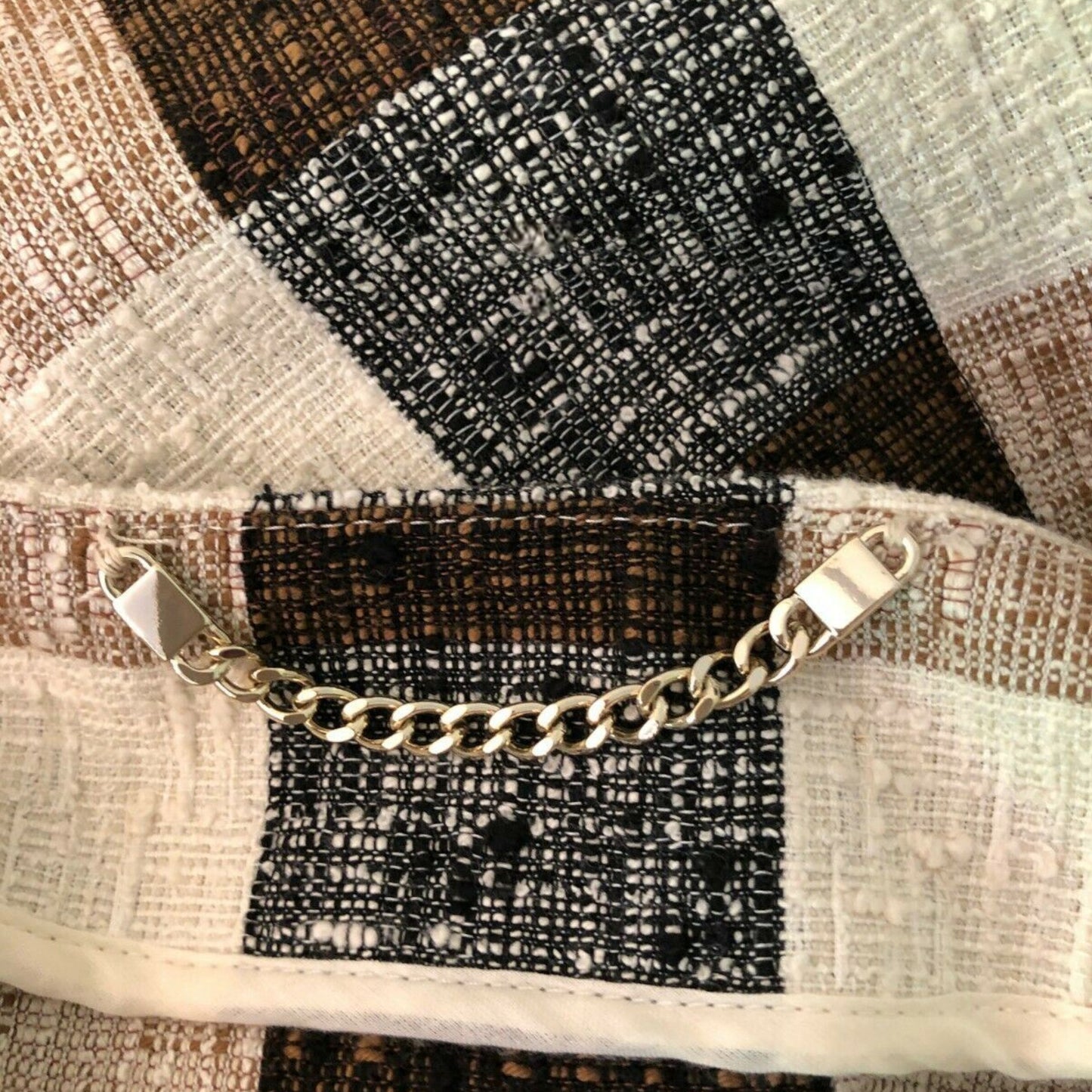 Gold chain on a textured fabric background