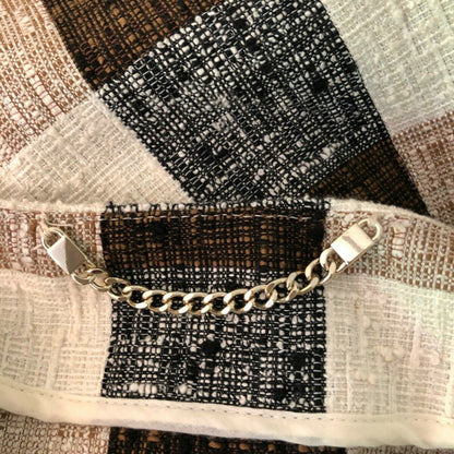 Gold chain on a textured fabric background