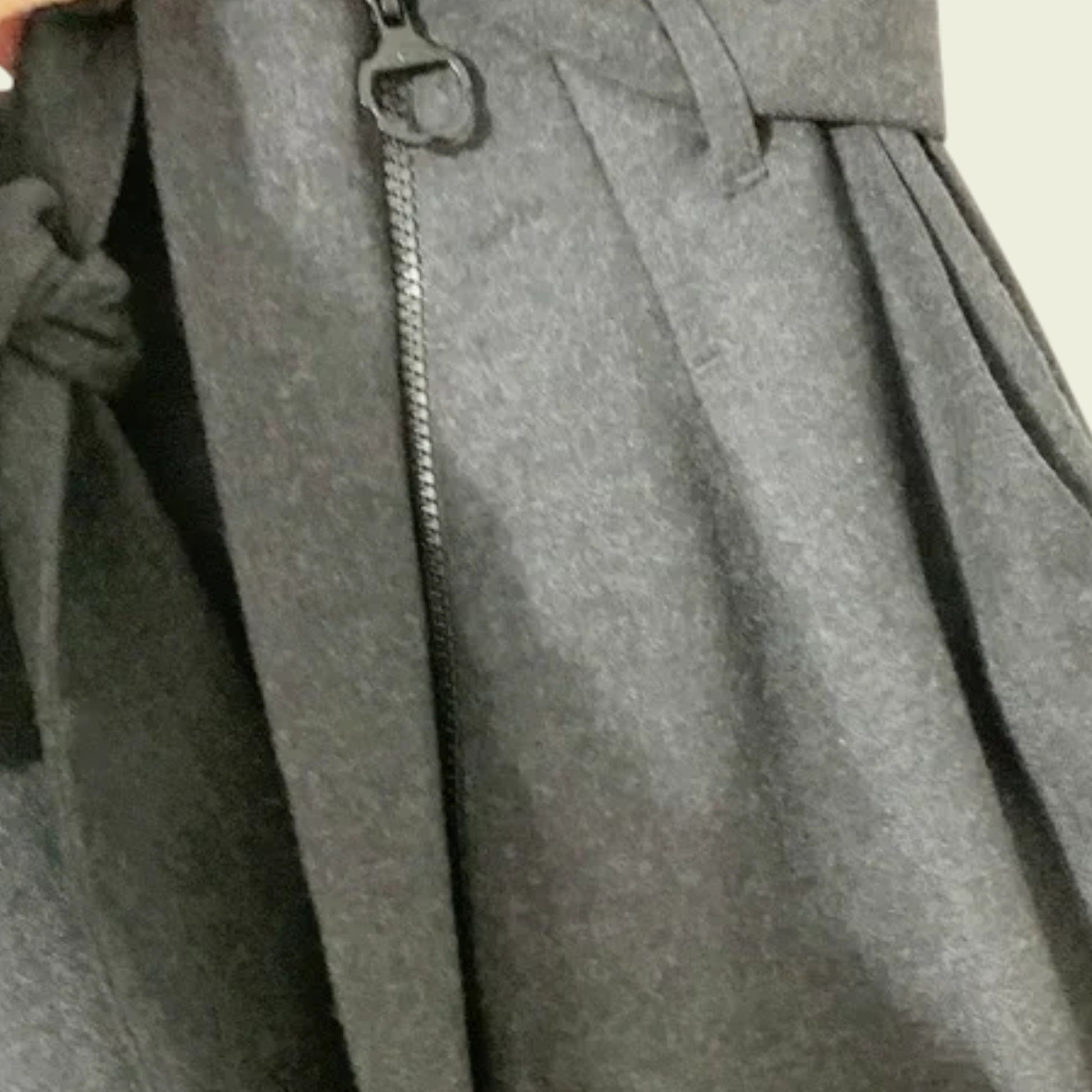 Close-up of a gray skirt with a zipper