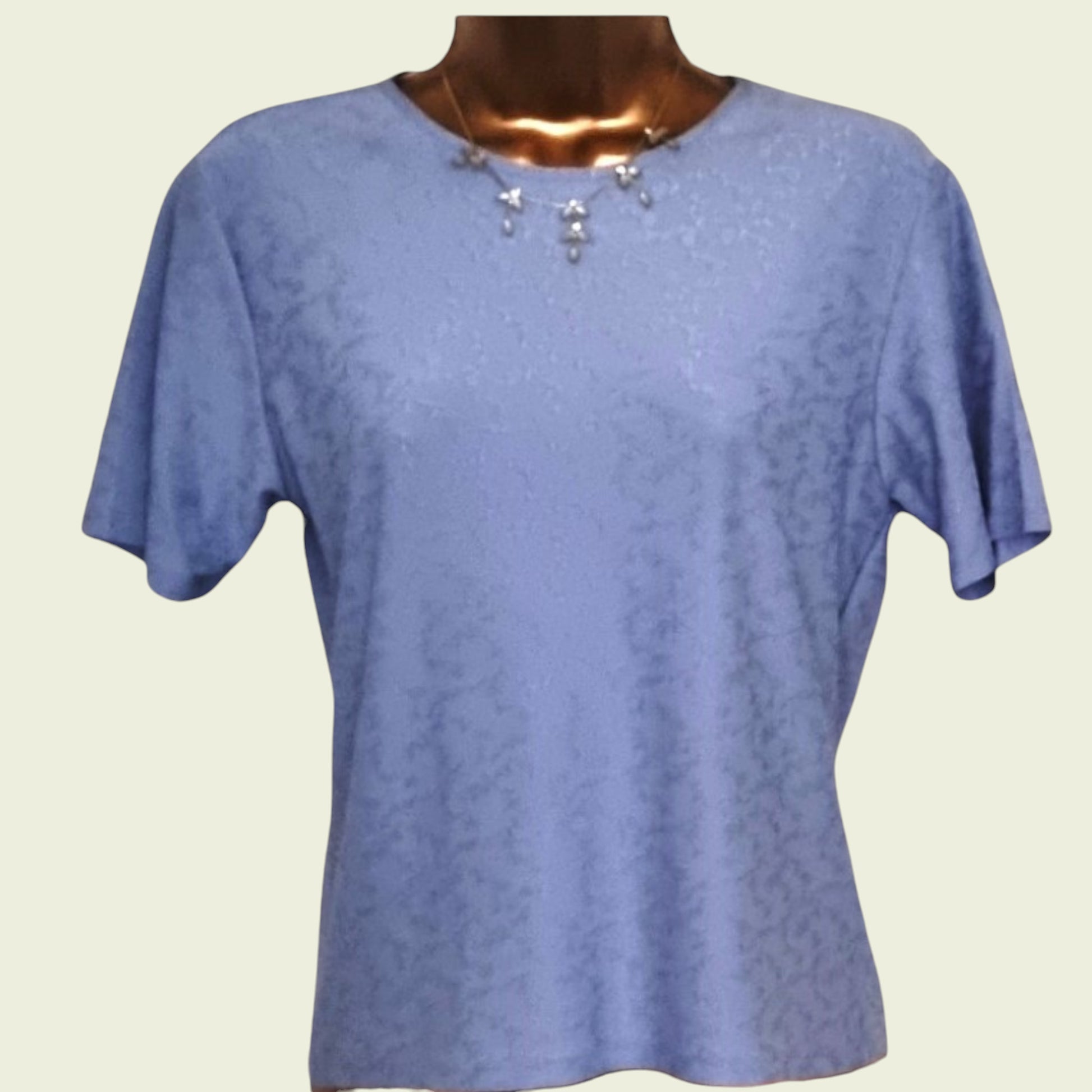 Blue t-shirt on a mannequin with a plain background