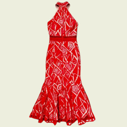 Red and white patterned halter neck dress on a beige background