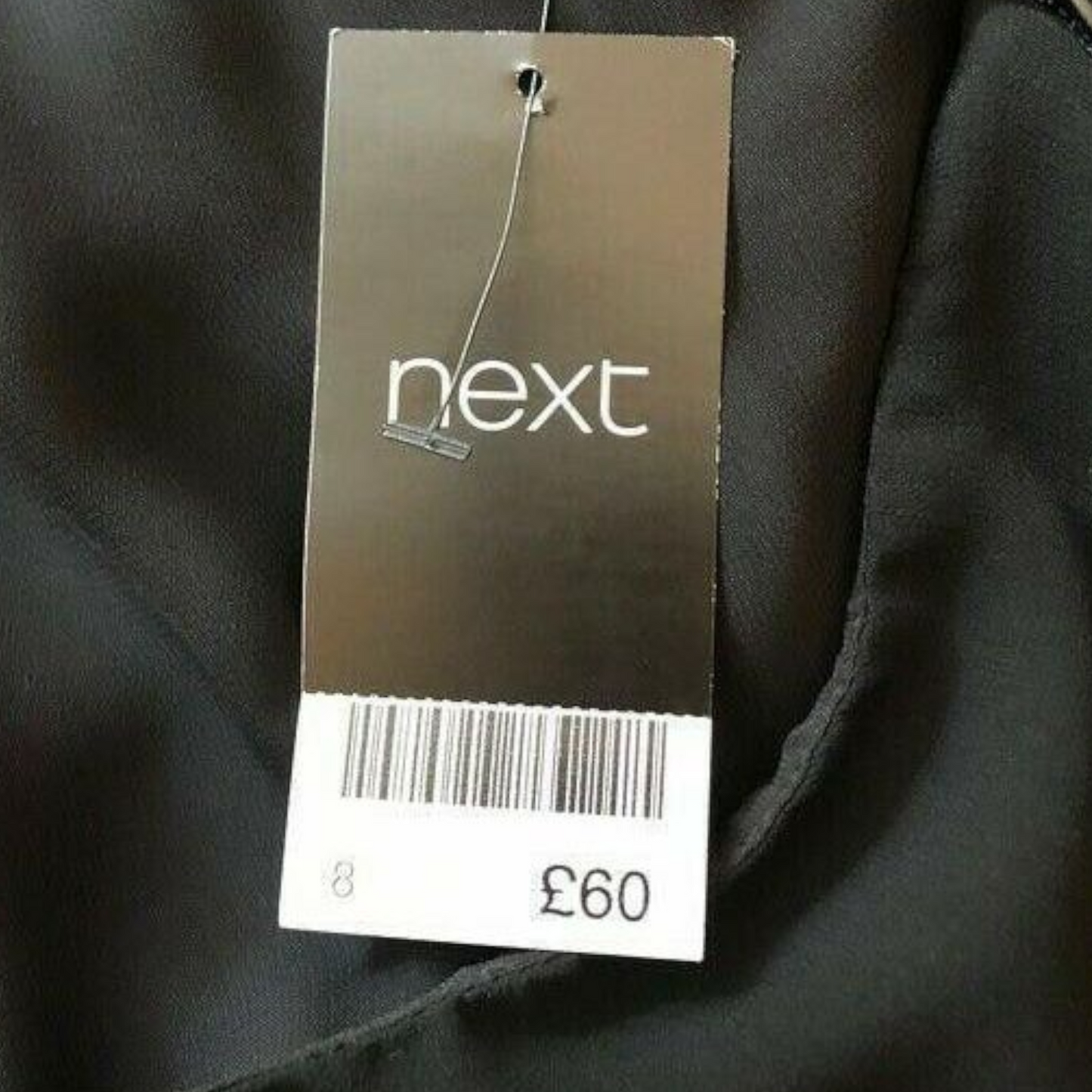 Black garment with a 'next' brand tag showing price £60