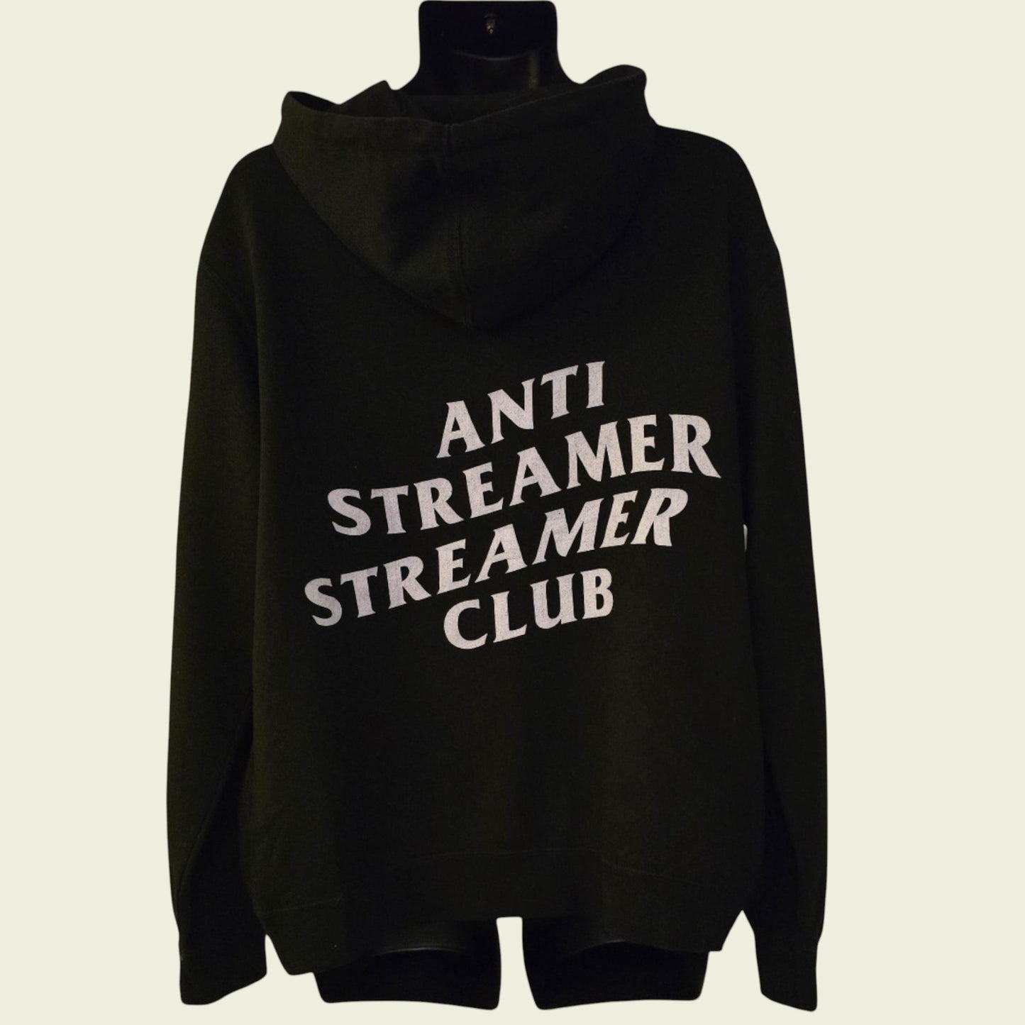 Black hoodie with 'ANTI STREAMER STREAMER CLUB' text on a beige background