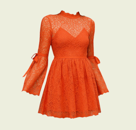 Orange lace dress with long sleeves and bow details on a beige background