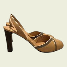 Tan high-heeled shoe on a beige background