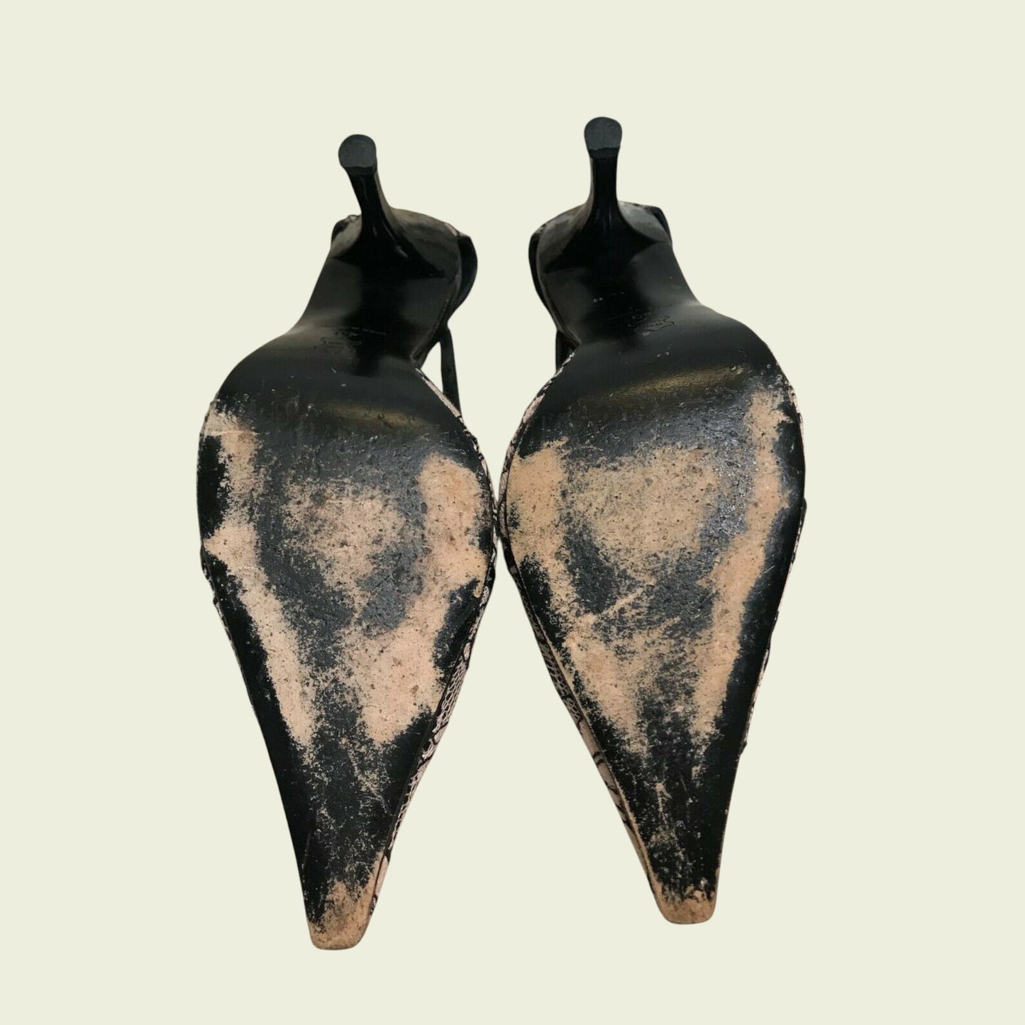 Shoe soles and heels on a beige background