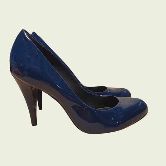 Blue high-heeled shoes on a beige background
