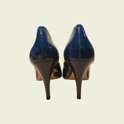 Pair of blue high-heeled shoes on a beige background