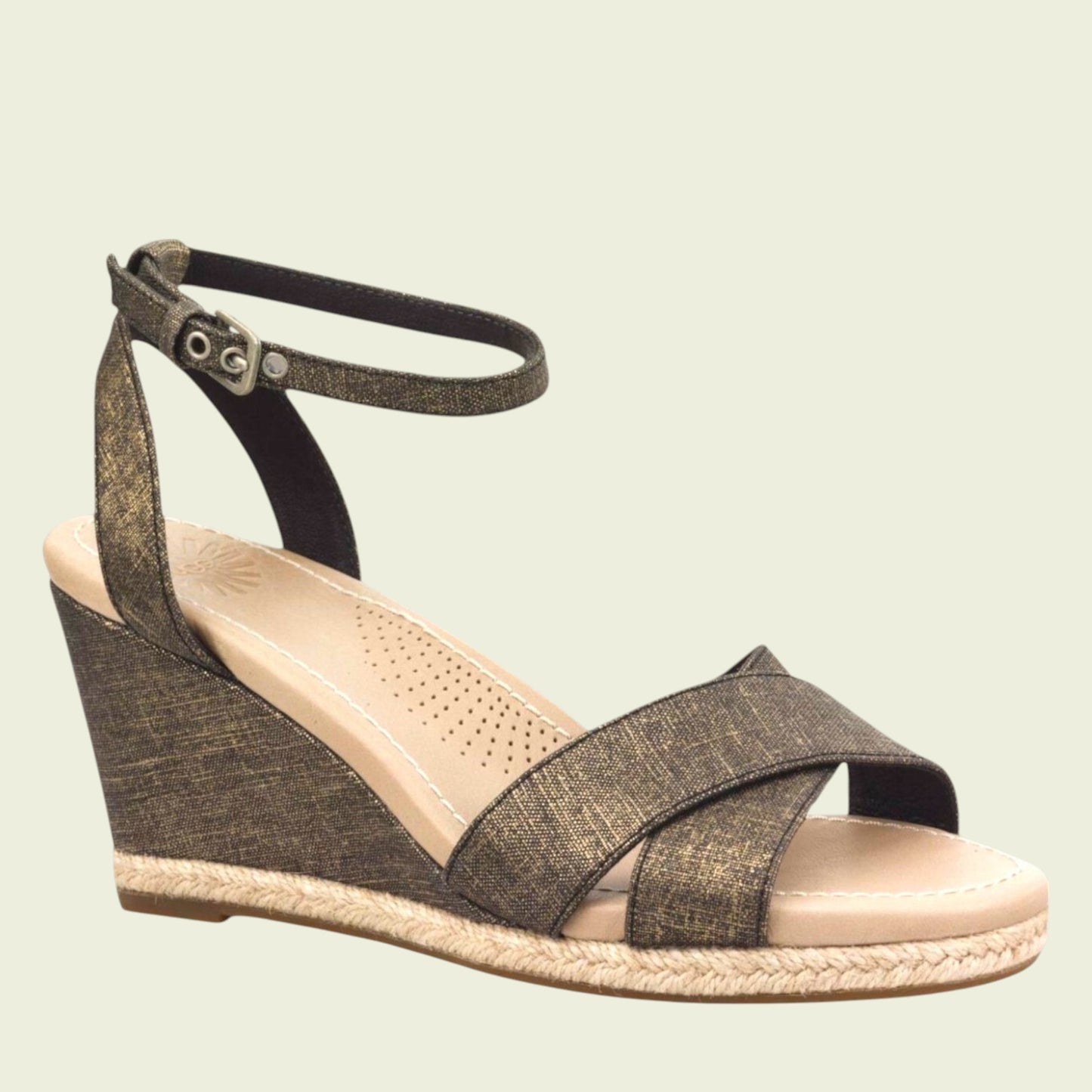 Wedge sandal with criss-cross straps on a beige background