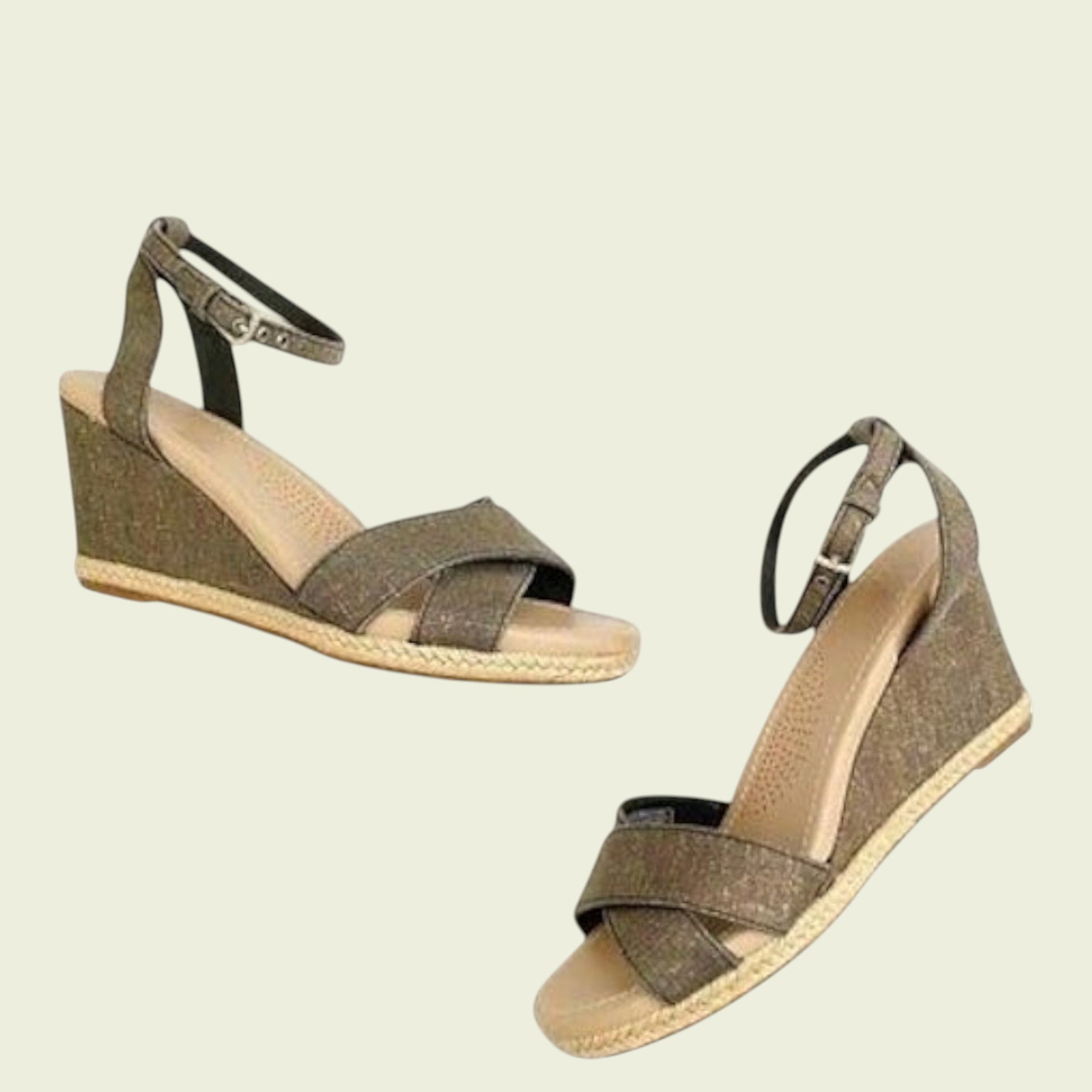 Pair of brown wedge sandals on a beige background