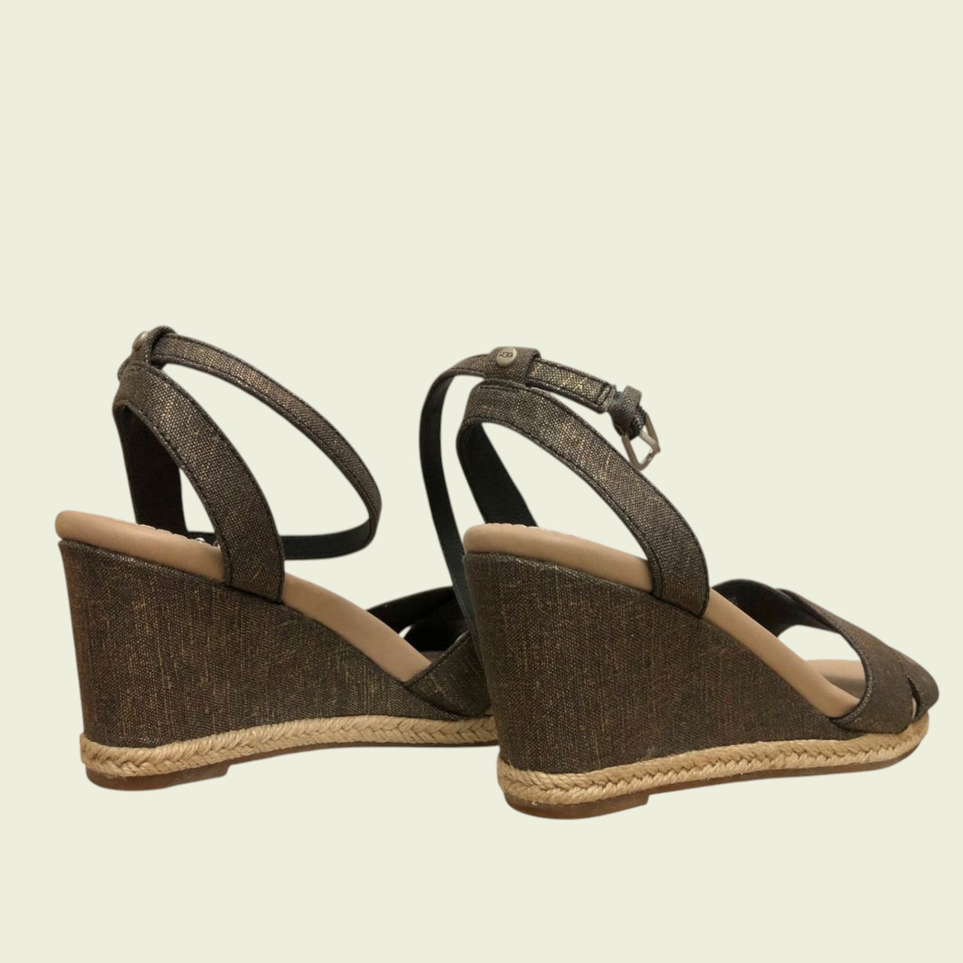 Brown wedge sandals with jute sole on a beige background