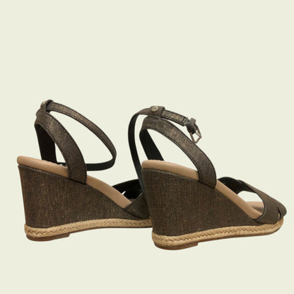 Brown wedge sandals with jute sole on a beige background