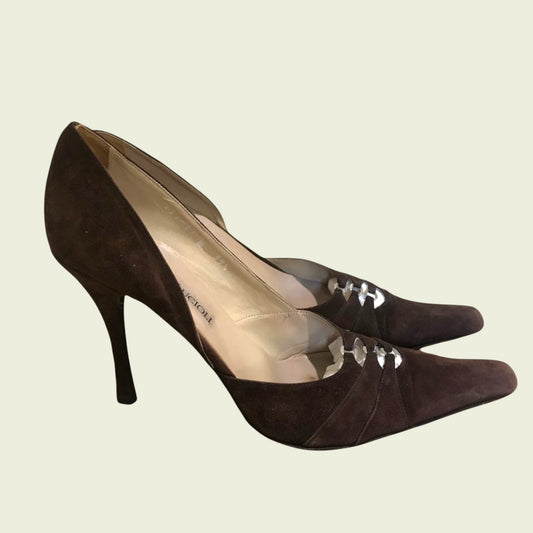Brown high-heeled shoes on a beige background