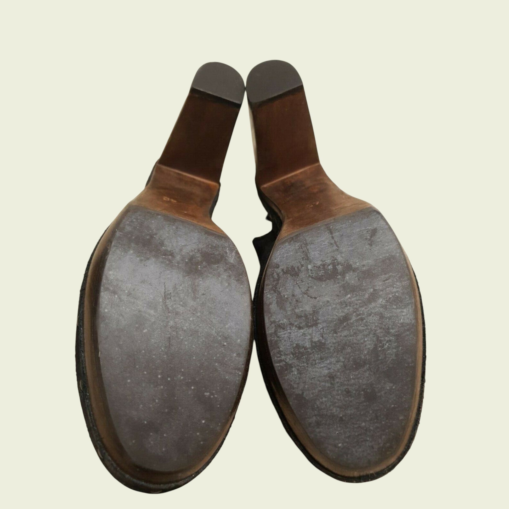 Pair of leather shoe soles on a beige background