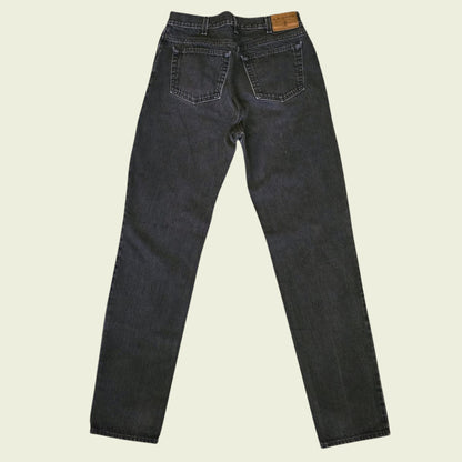 Pair of black jeans on a beige background
