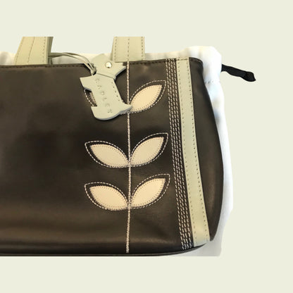 Brown bag with beige leaf designs on a white background