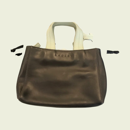 Brown leather handbag with 'Radley' branding on a beige background