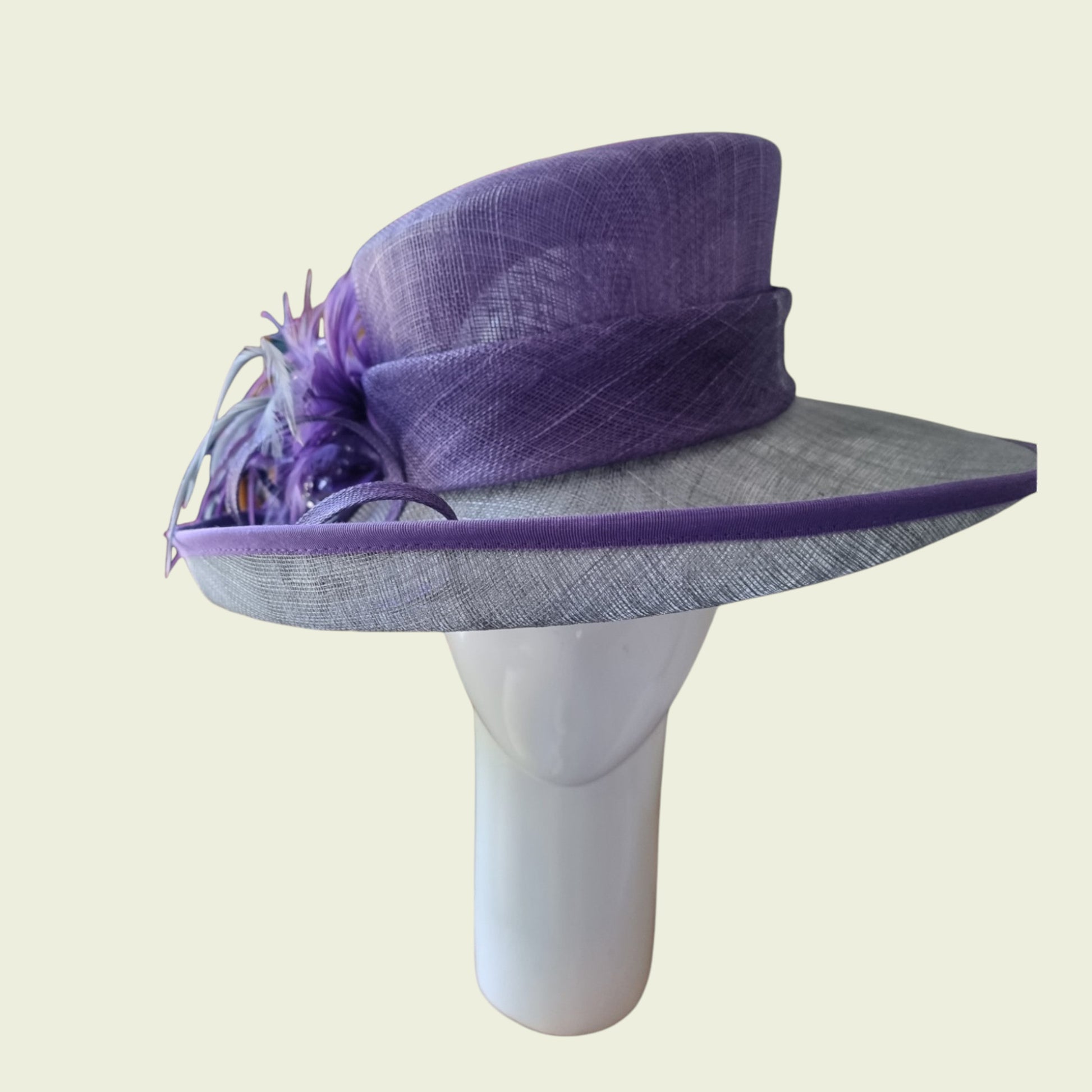 Side view of mauve hat on beige background