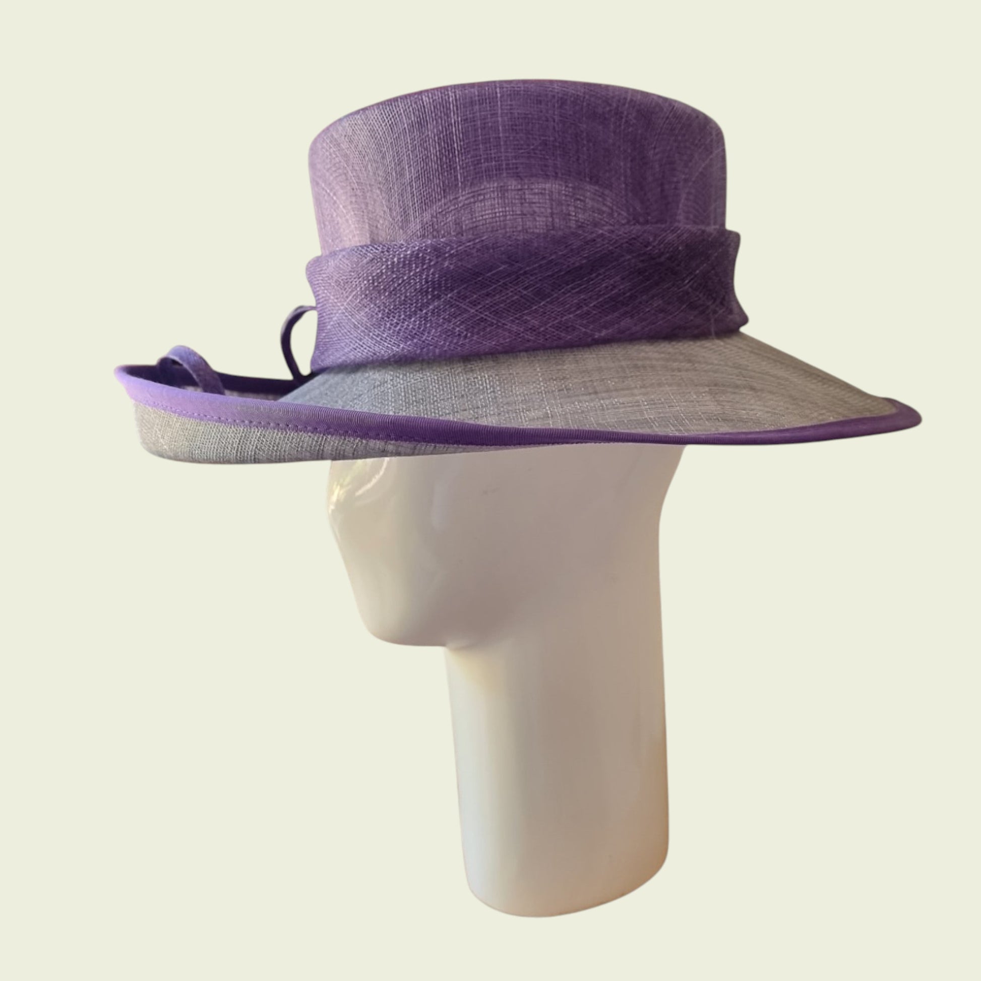 Side view of mauve hat on beige background