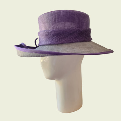 Side view of mauve hat on beige background