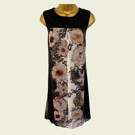 Black sleeveless dress with floral pattern on a mannequin against a beige background