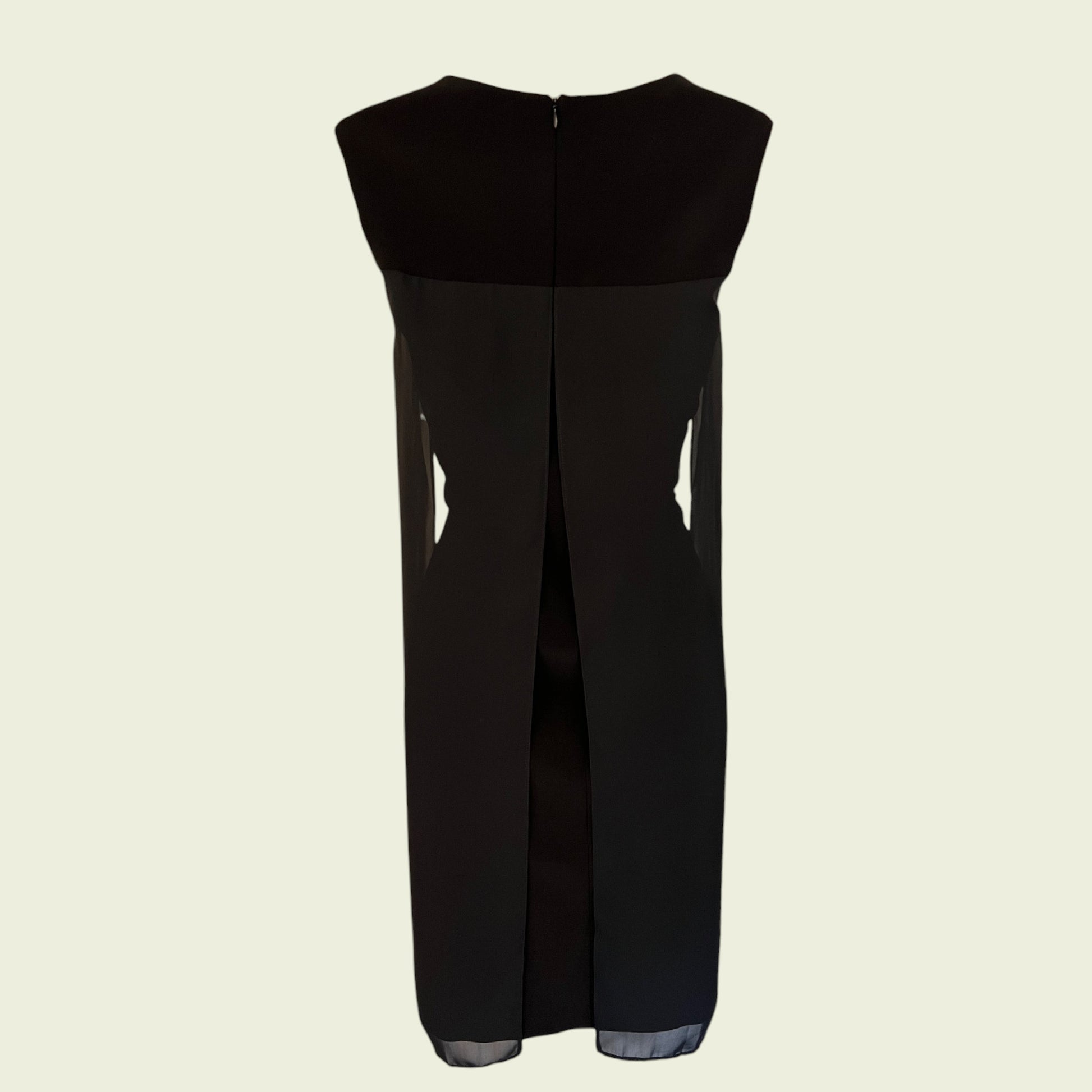Back of black sleeveless dress on a beige background