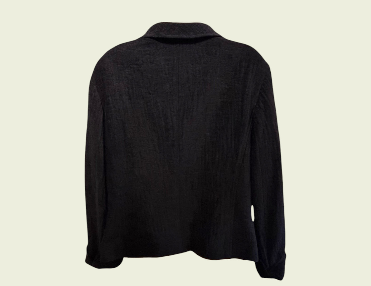 Black long-sleeve jacket on a beige background