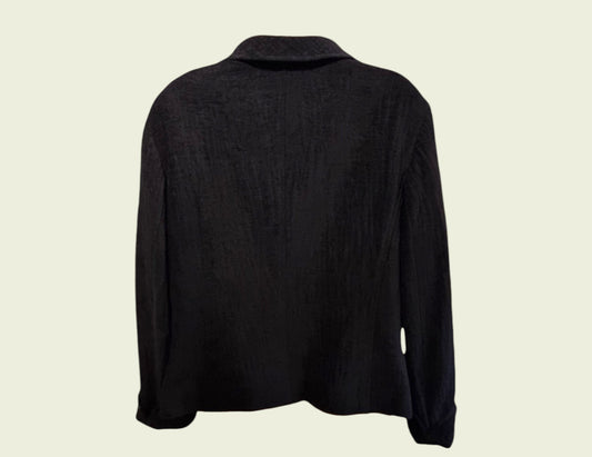 Black long-sleeve jacket on a beige background