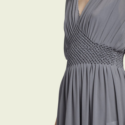 Gray dress with a textured waistband on a beige background