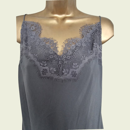 Gray lace-trimmed top on a mannequin against a beige background