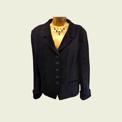 Black blazer on a mannequin with a plain background